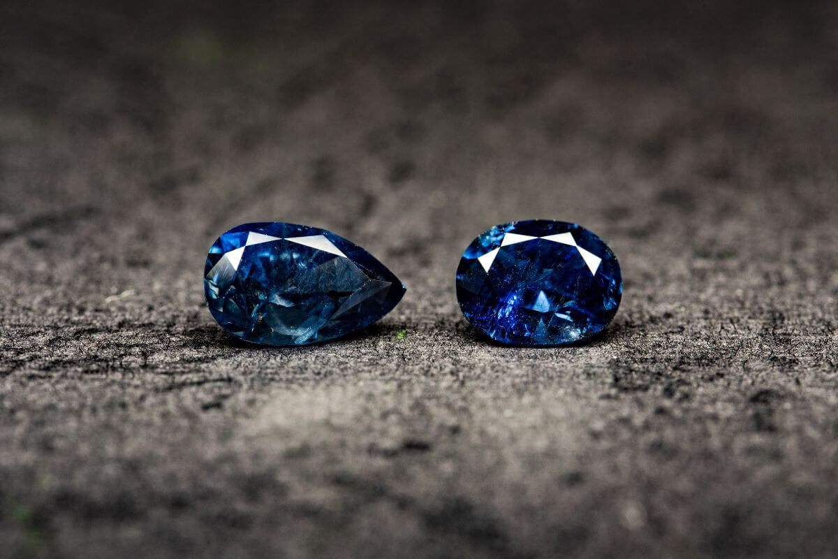 Two Blue Sapphire Studs on a Dark Surface in Montana