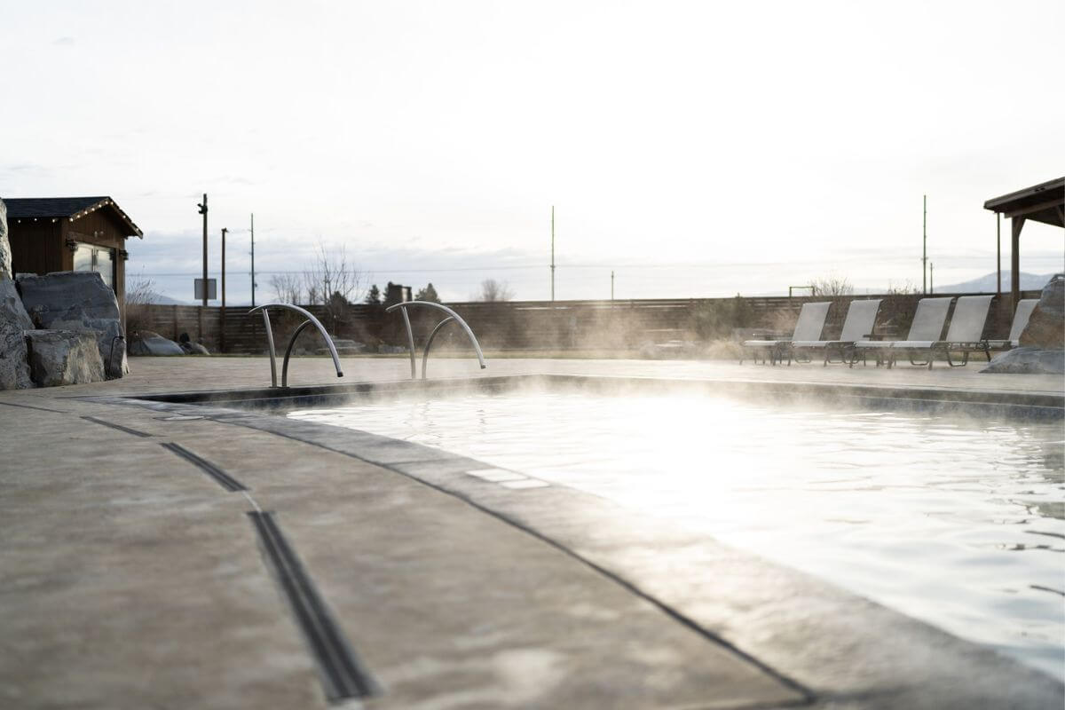 Steam rises from Bozeman Hot Springs's relaxing outdoor pool.