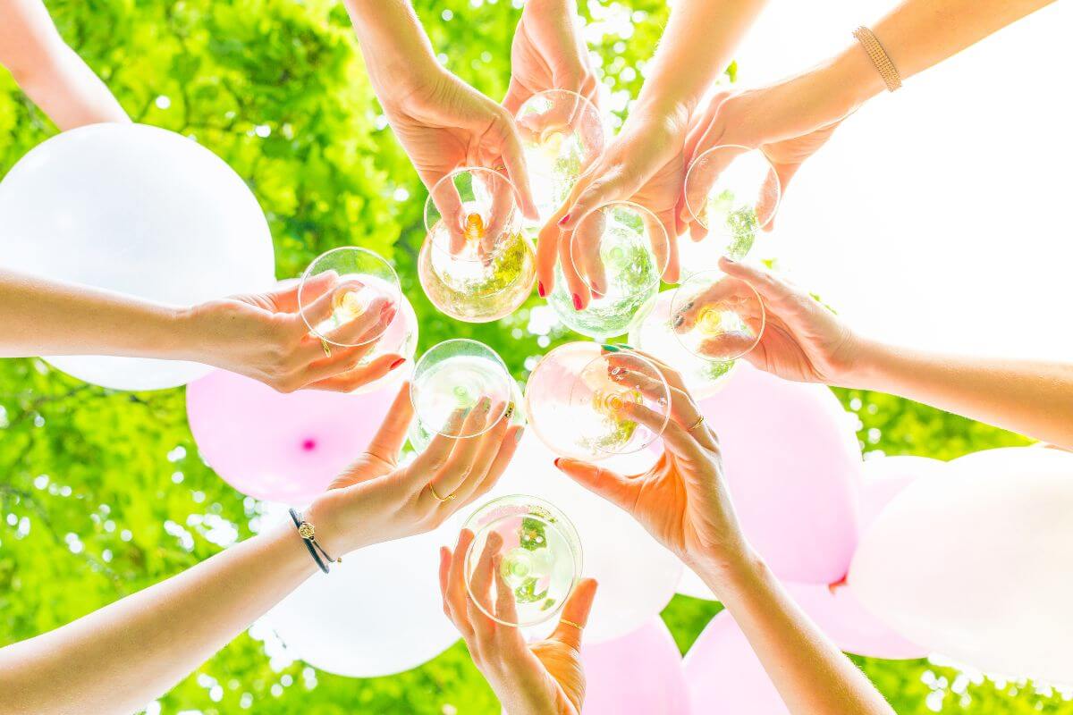 A group of girls raise their champagne glasses in a toast, celebrating a bachelorette party in Montana.