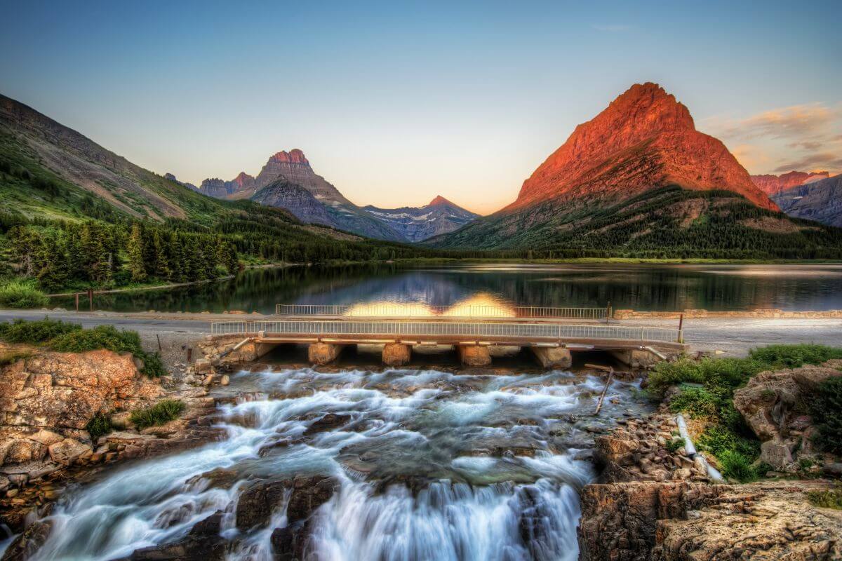 A lake with a waterfall in Glacier National Park