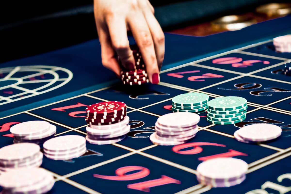 A person playing roulette at a casino table.