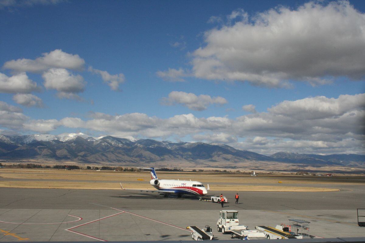 A plane is parked on the tarmac at a Montana airport.