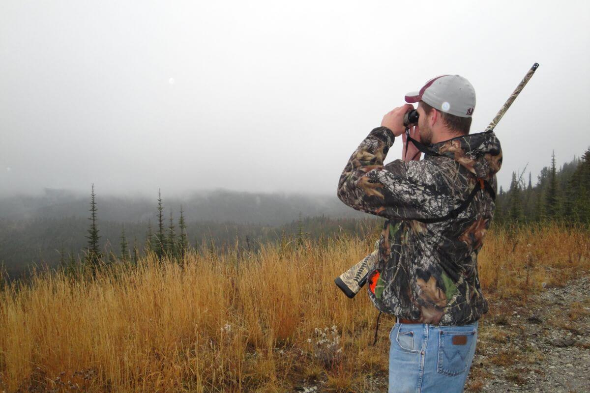 A hunter scans a designated hunting area in Montana during hunting season, searching for potential game.
