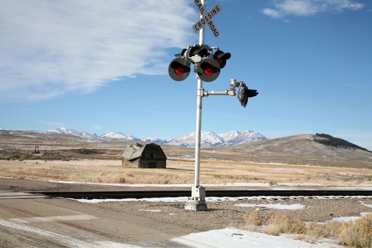 A railroad crossing in the middle of a field in Montana.