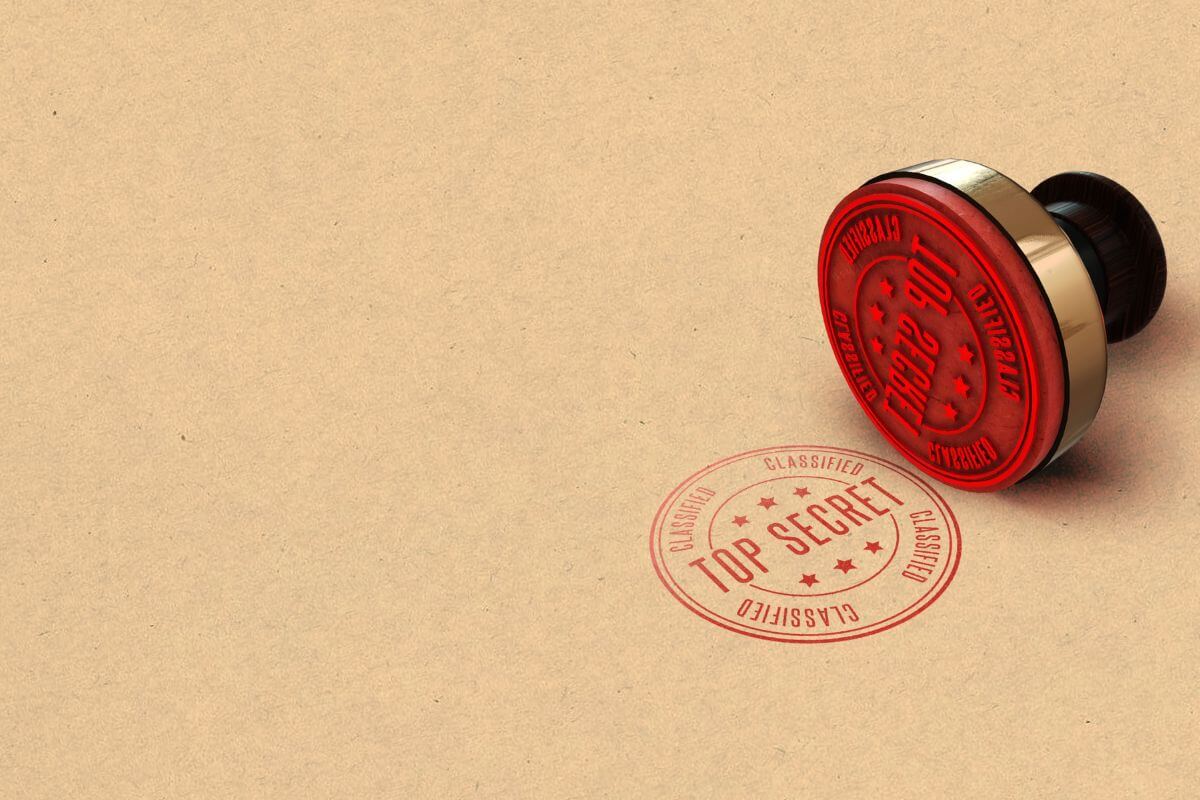 A red rubber stamp sitting on top of a paper.