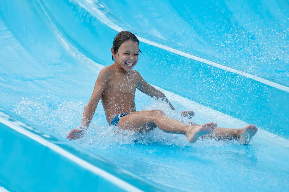 A boy is sliding down a water slide at the Last Chance Splash Waterpark.