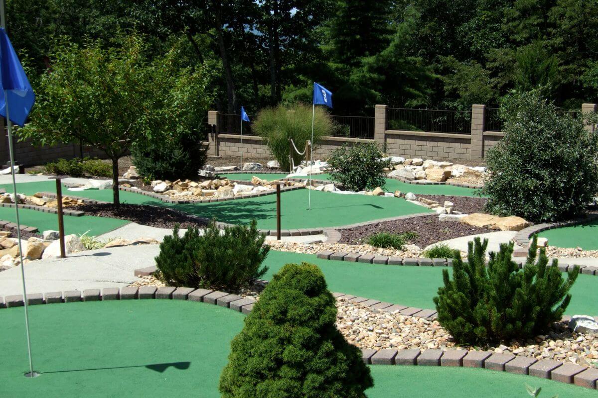 A top mini golf course in Montana landscaped with shrubs, small trees, and stone paths.