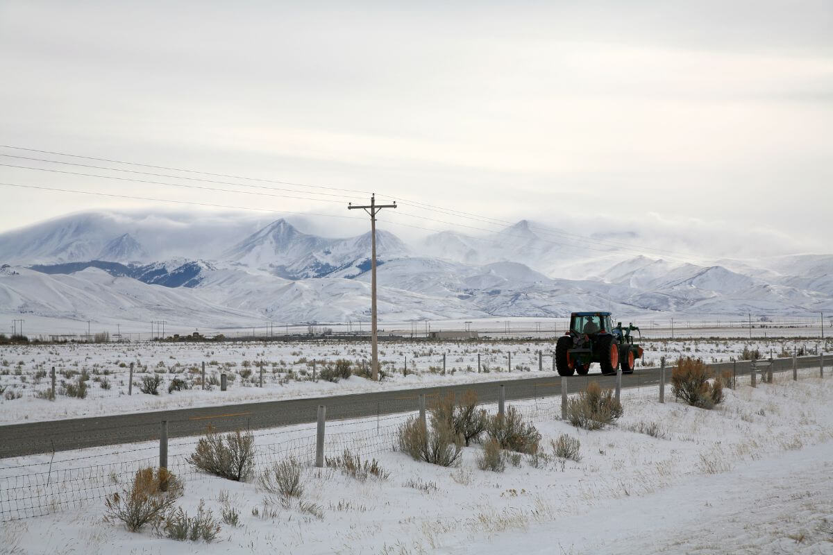 A tractor driving down a snowy road in Montana