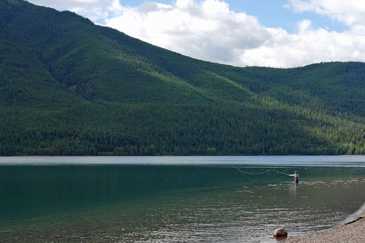 A man is enjoying his time fishing on a lake in Montana