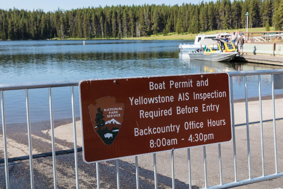 A sign at Yellowstone National Park requiring boat permits and inspections for Montana invasive species before entry.