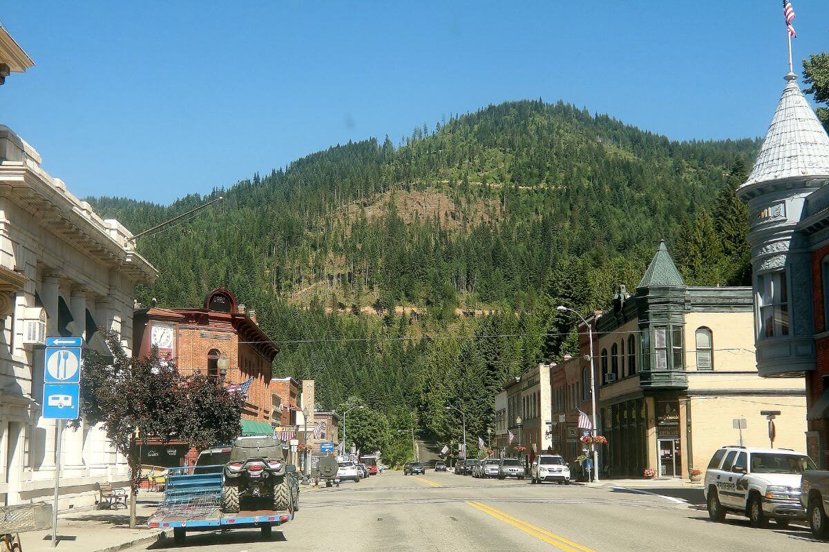 A rural town in Montana with a forested mountain in the background.