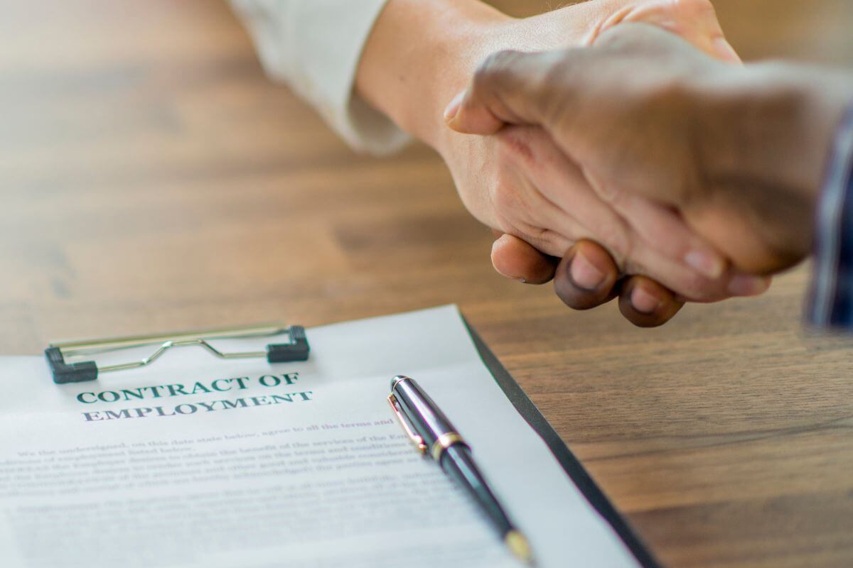 Two Man Shaking Hands on Top of an Employment Contract in Montana