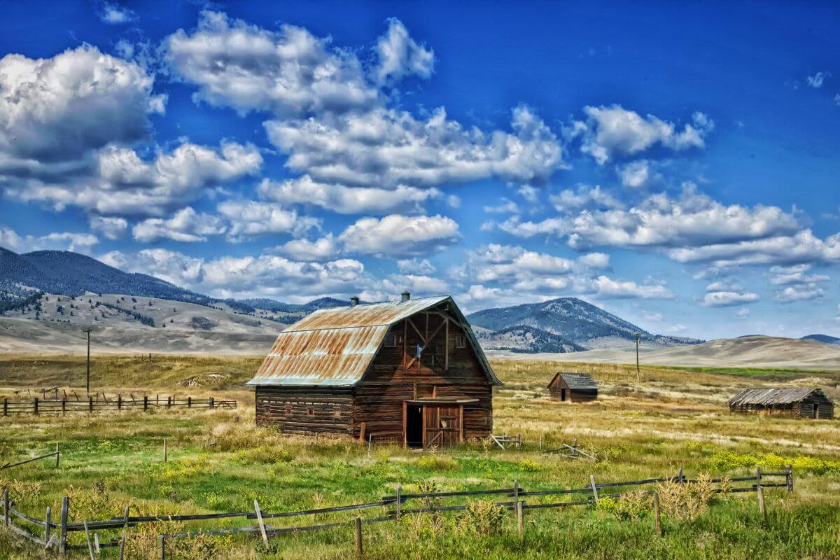 An old homestead in Montana with mountains in the background