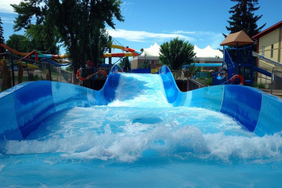 A close-up view of the starting point of a water slide with water rushing through it, as seen at Electric City Waterpark in Montana.