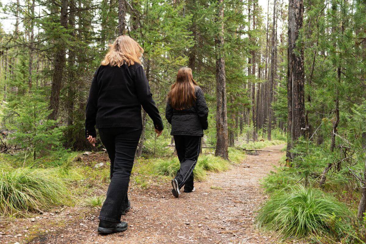 Two women hiking in the Montana woods.