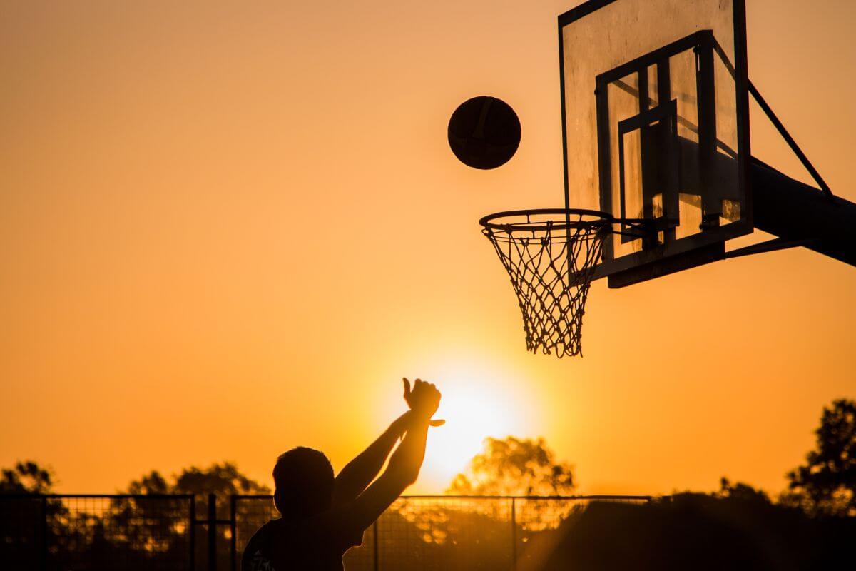 Sillhouette of Man Playing Basketball