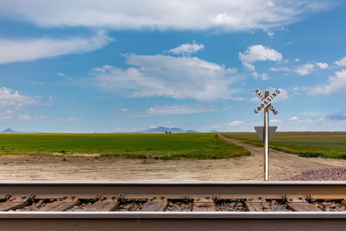 A train track amid a picturesque grassy field.