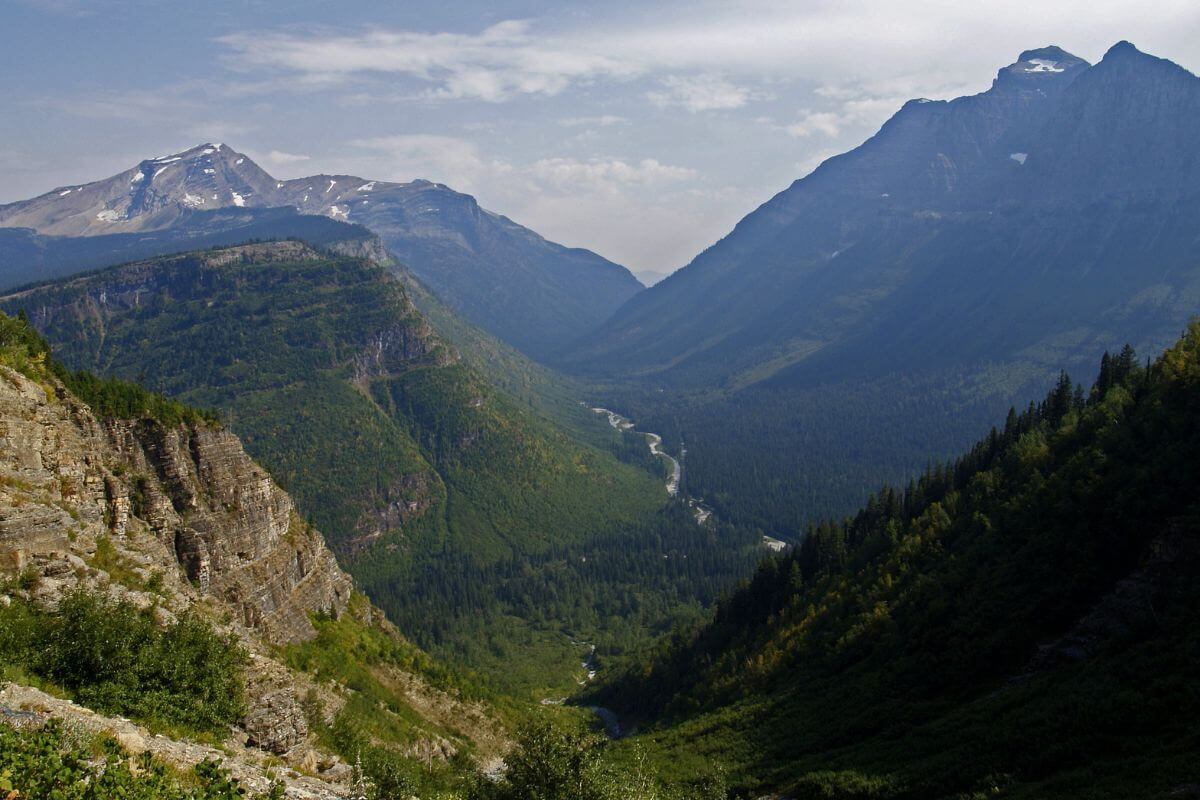 A panoramic view of a valley nestled in the picturesque mountains of Montana.