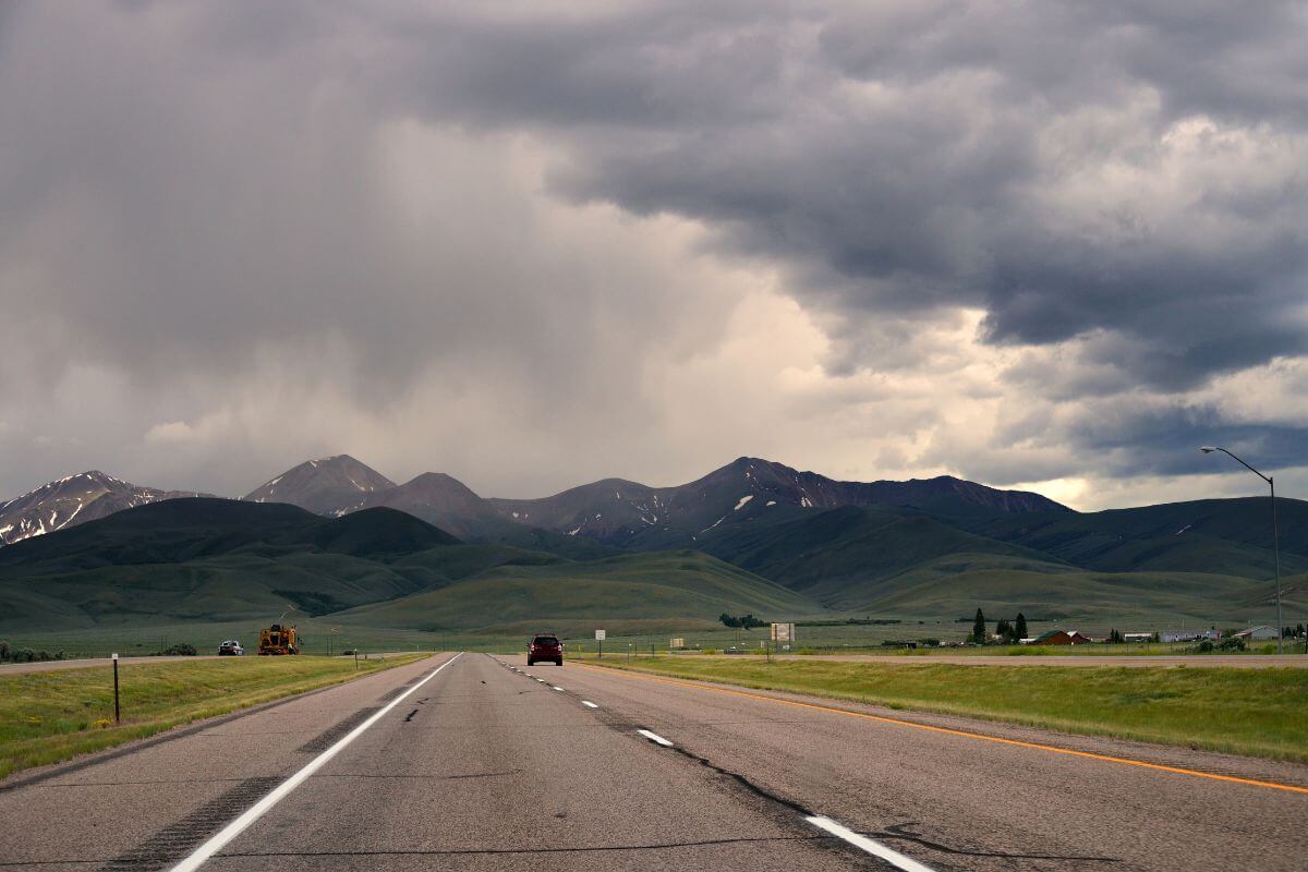Dark clouds loom over the mountains in Montana, signaling an impending storm.