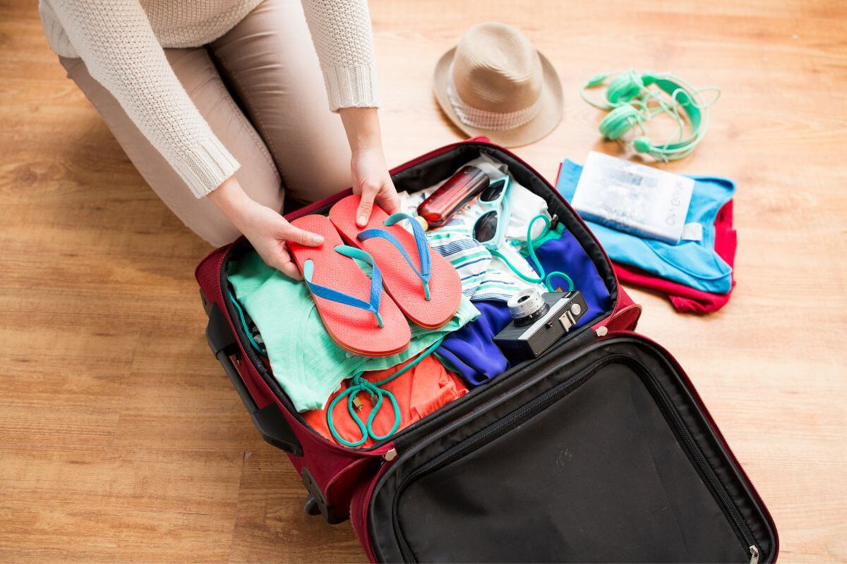A person packing a suitcase for their Montana vacation.