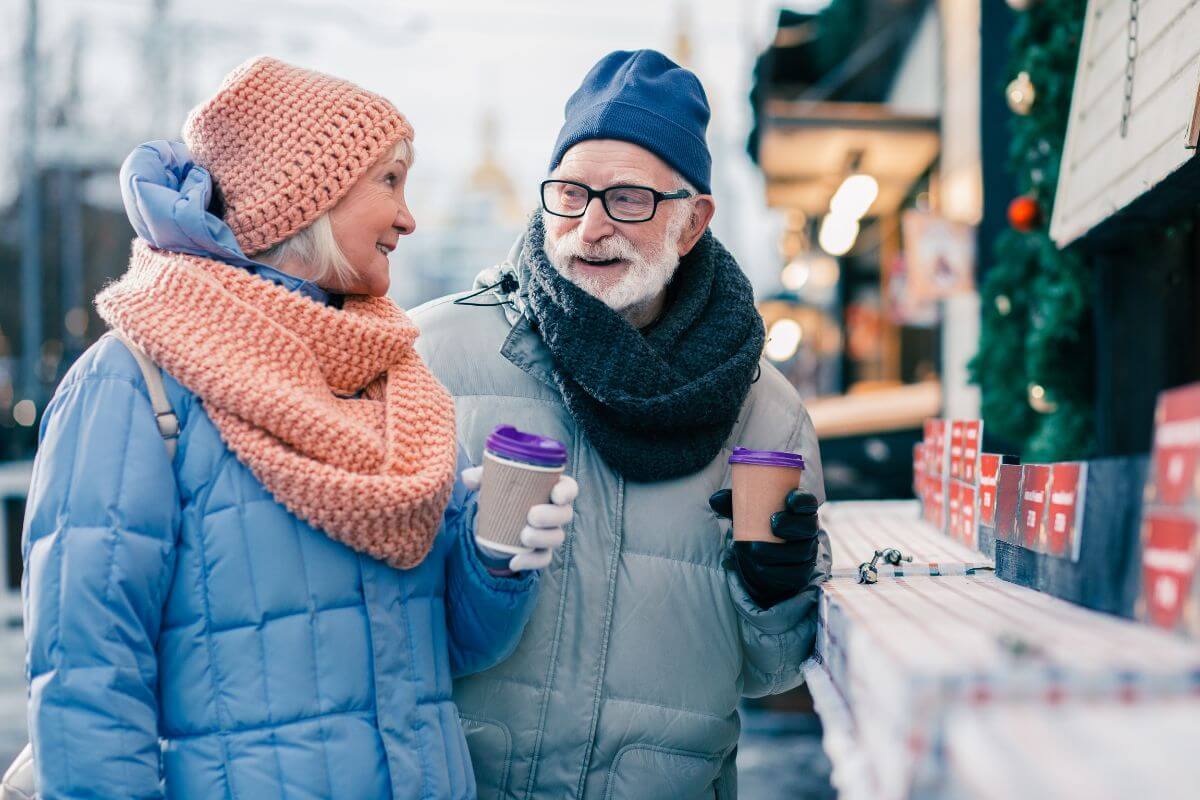 An older couple buying coffee at a winter market in Montana.