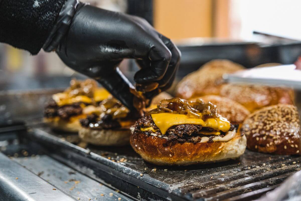 A person in Montana is preparing burgers on a grill