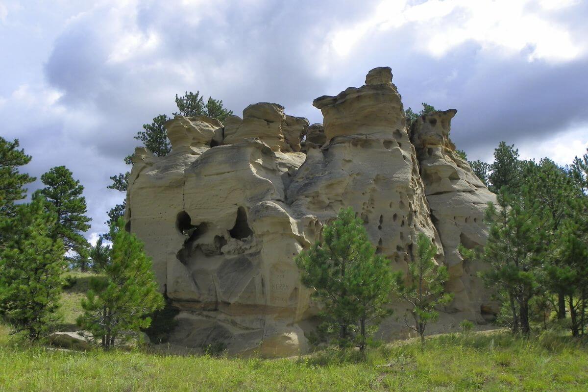 A large rock formation surrounded by trees in Medicine Rocks State Park.