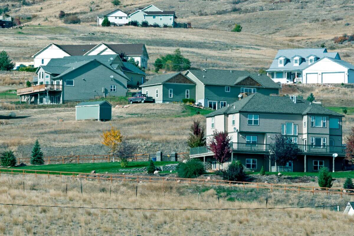 A group of houses on a rural hillside in Montana.