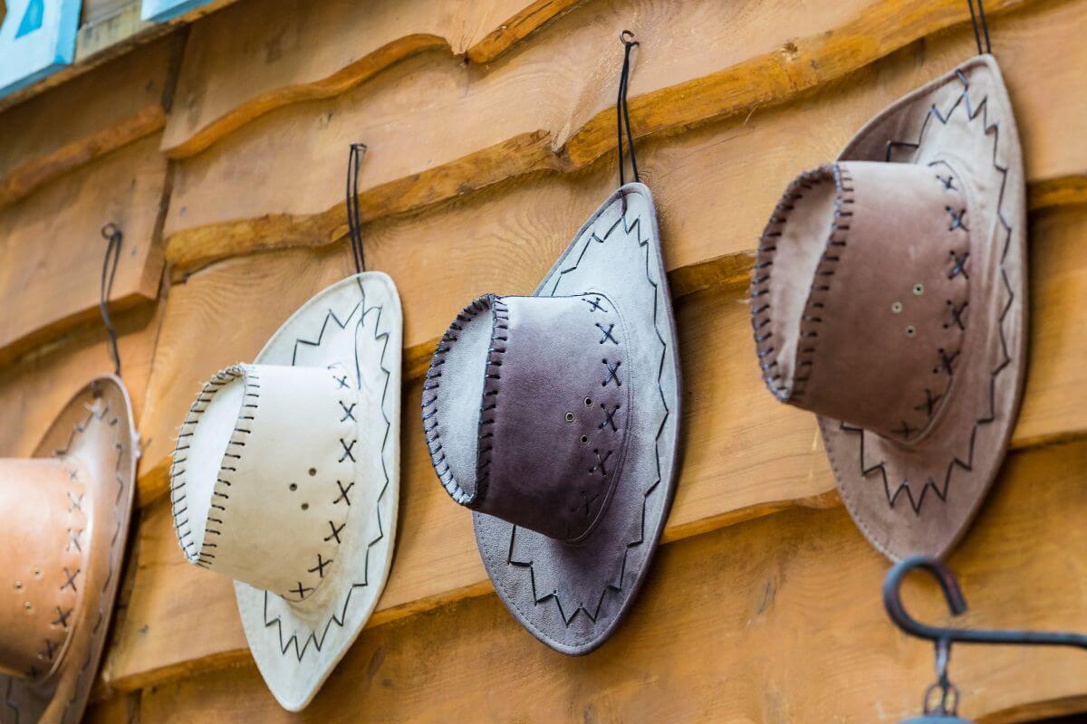 Cowboy hats hanging on a wooden wall in Montana.