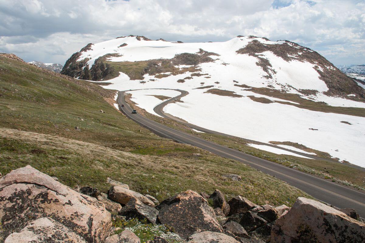 A winding road on a snow-covered mountain at Beartooth Highway, Montana.
