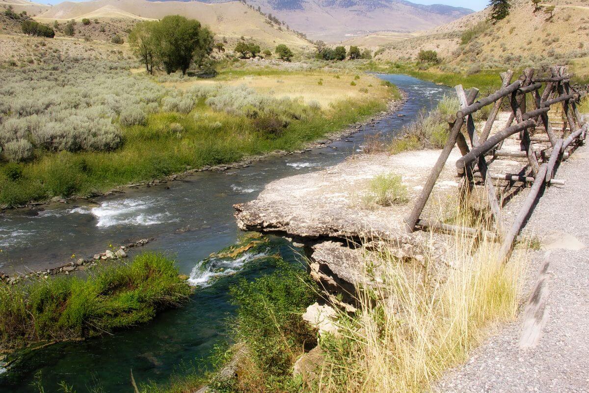 
A small cliff overlooking a river that leads to a popular hot spring in Montana is barricaded to help prevent accidental falls.