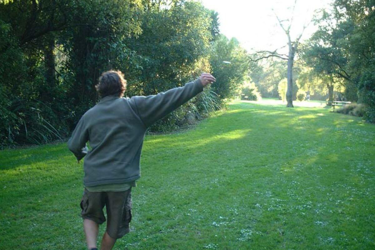 A man throwing a frisbee in a park in Montana.