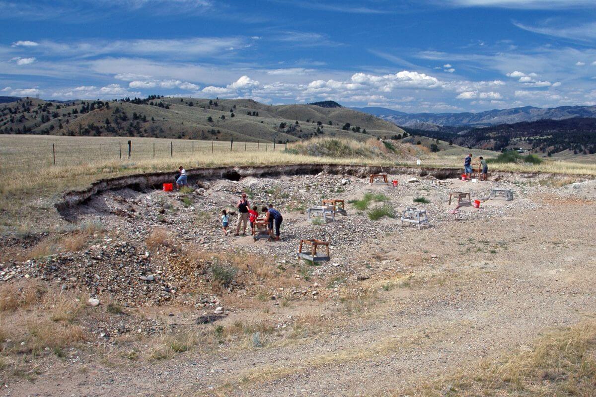 A group of people standing on a dirt road at Spokane Bar Sapphire Mine, one of the best places for gemstone mining in Montana.