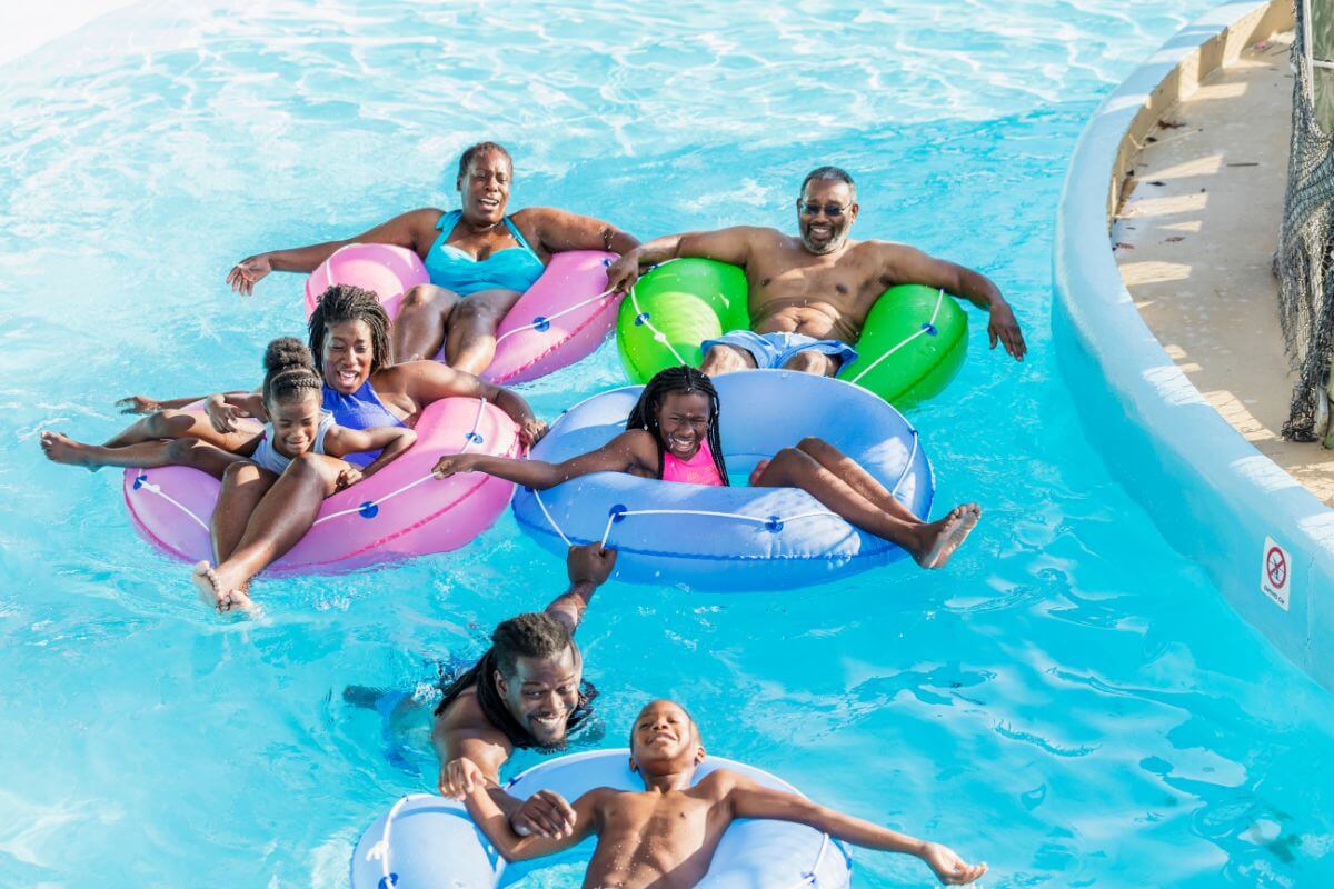 A family rides inflatable circular pool floats at Montana's Electric City Waterpark.