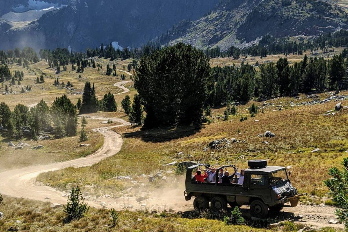 A group enjoys a Montana jeep tour with Hawley Mountain Guest Ranch through the wilderness near Yellowstone.
