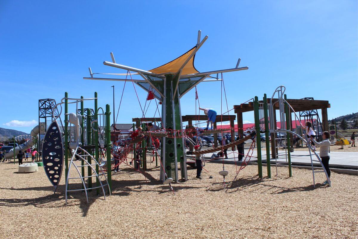 A playground with a swing set in Butte's Stodden Park, home of Ridge Waters Waterpark.