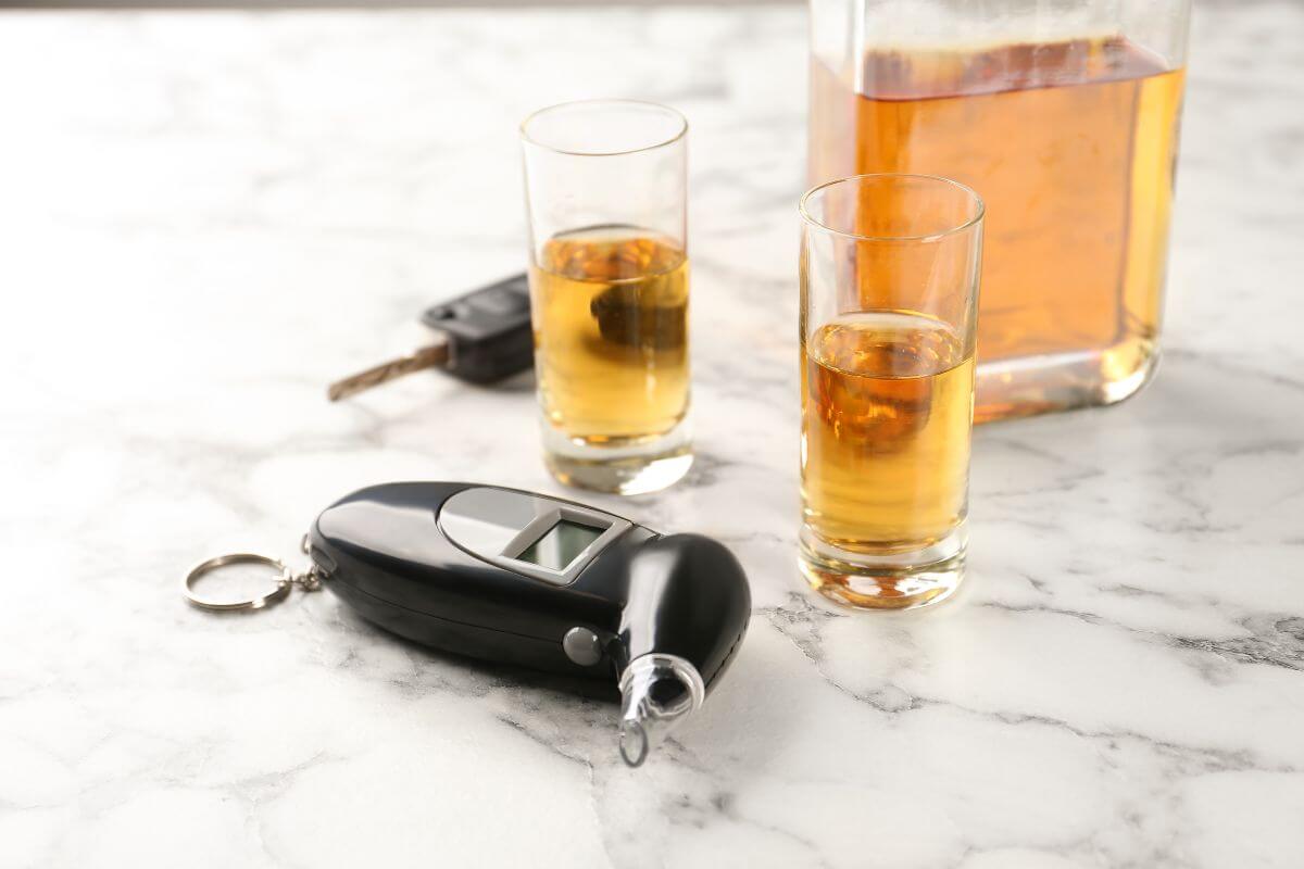 Shot Glass with Alcohol and Car Keys