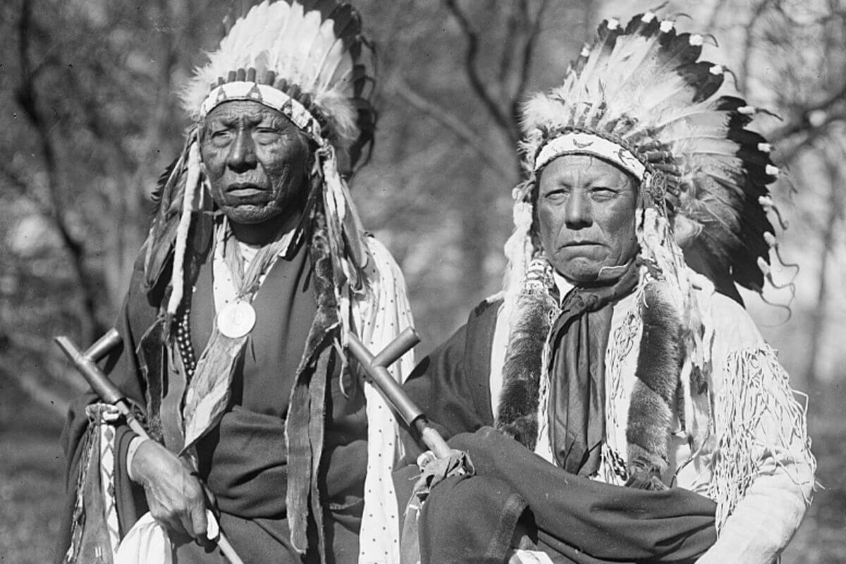 Two Montana natives adorned in traditional Indian headdresses showcasing their rich legacy.