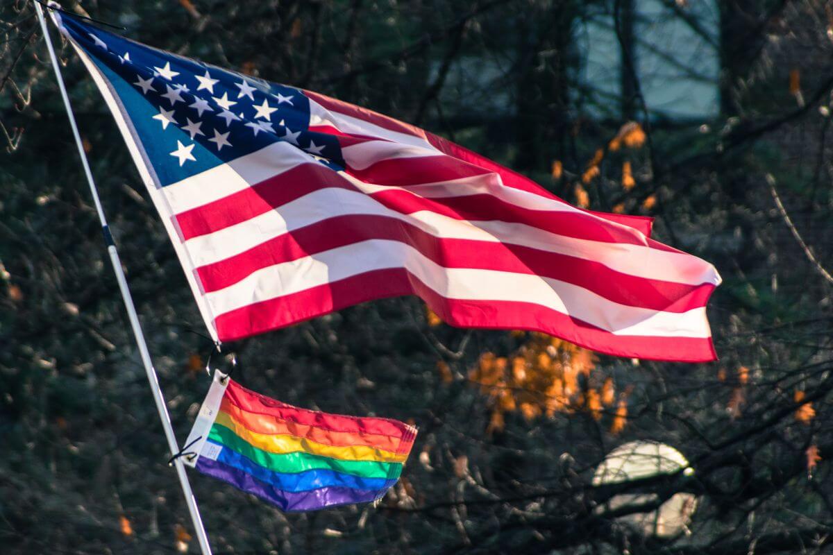 An American flag and a rainbow colored flag