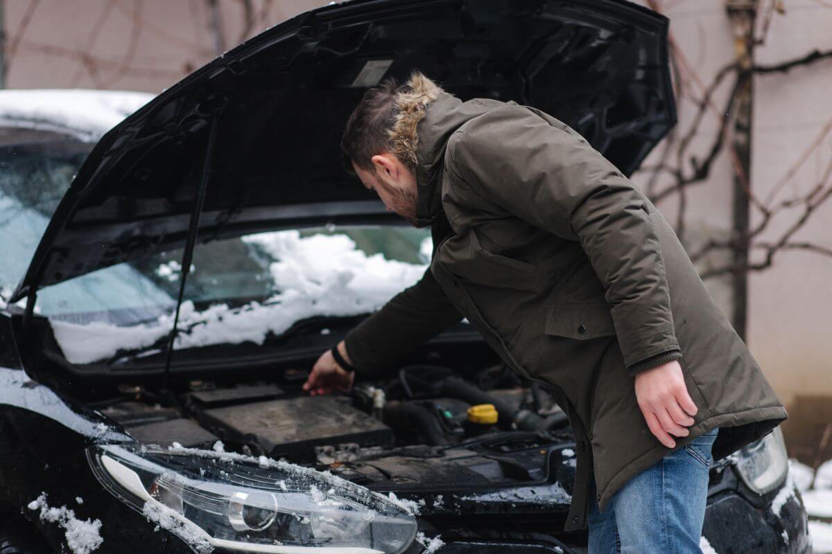 A man checks his car's engine in Montana