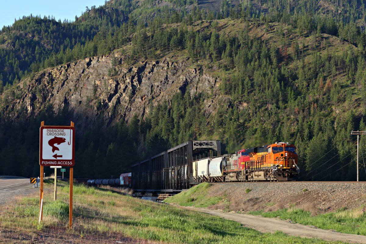 A train traveling down a railroad track in Montana.
