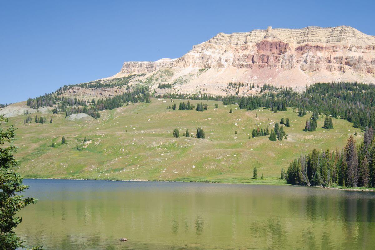 Experience the breathtaking beauty of a lake nestled in the stunning Montana mountains during your best Montana vacations.