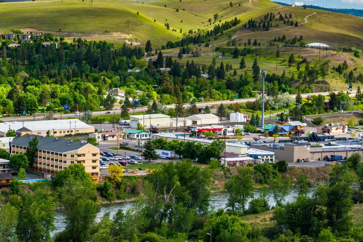 An aerial view of a town with trees and a river in Montana.
