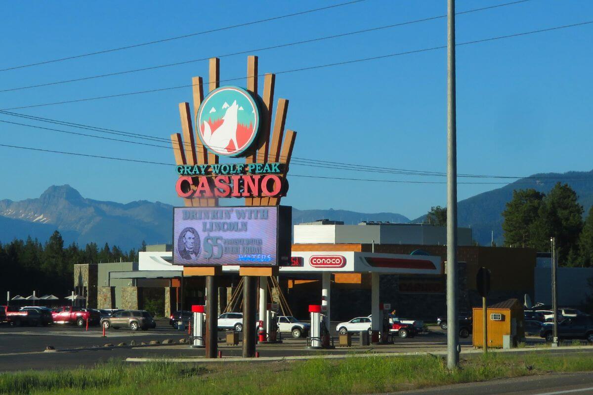 A casino with a large sign nestled among the majestic Montana mountains.