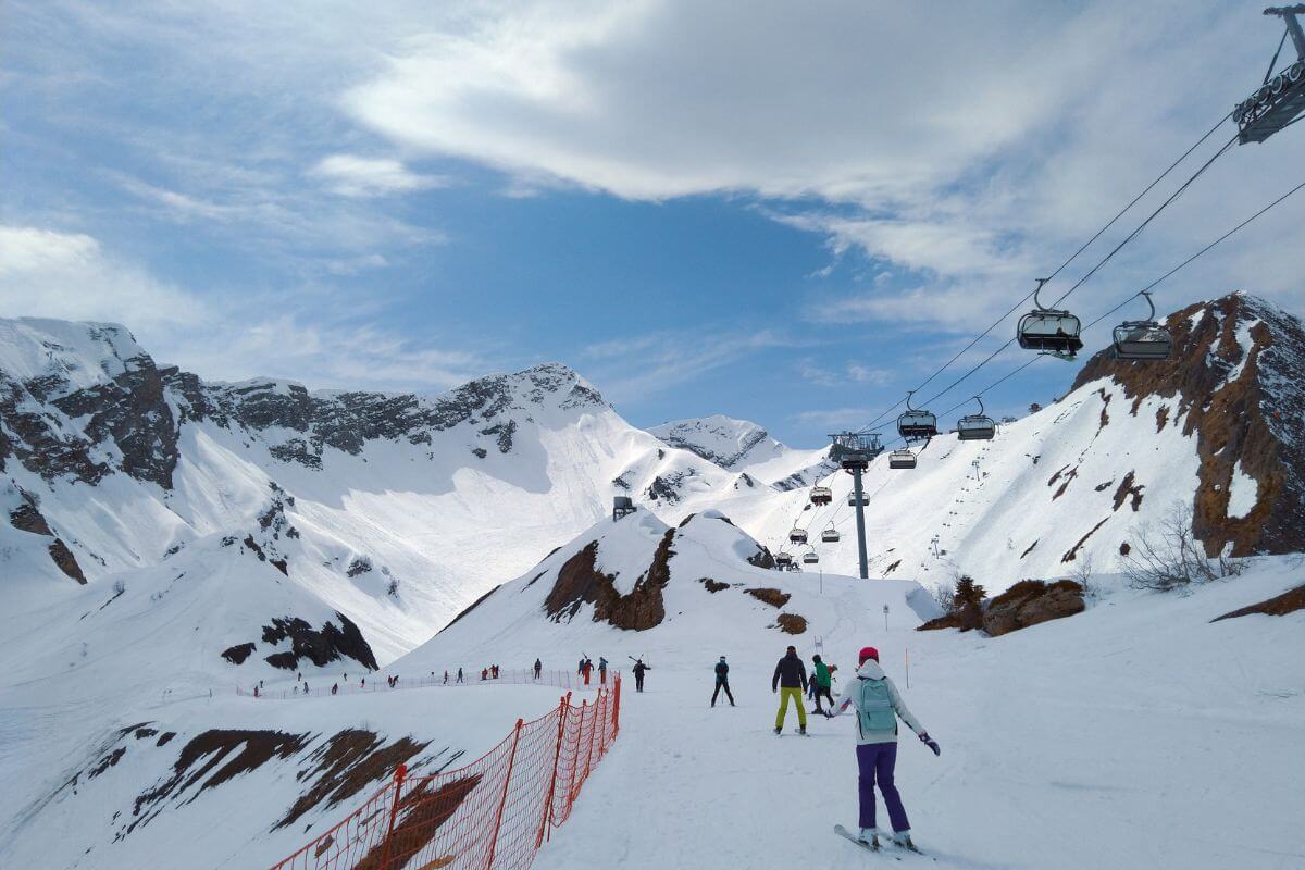 People ski down a slope in Montana's Big Sky Resort