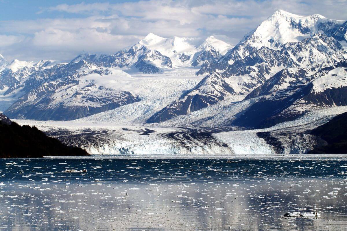 A glacial lake with snow-capped mountains in the background in Alaska.