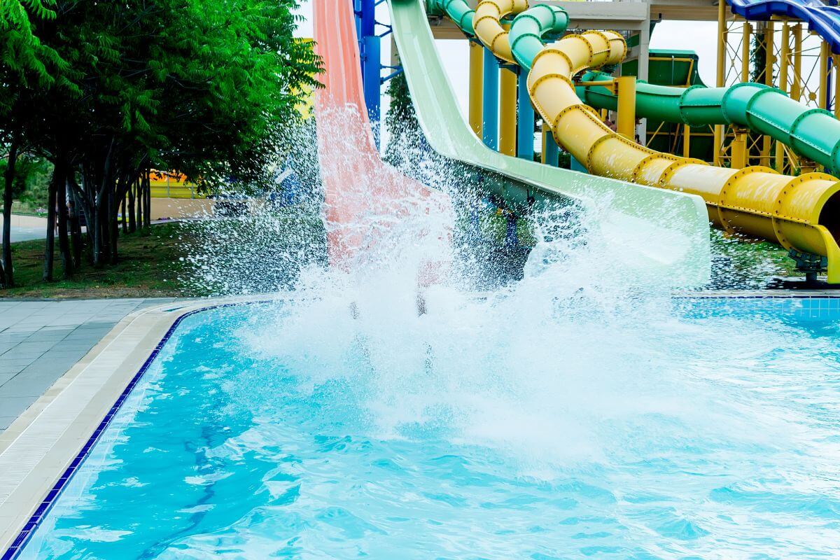 A person makes a big splash into the pool after riding a tall water slide at Montana's Electric City Waterpark.