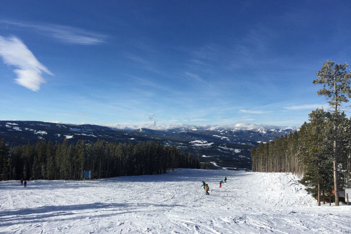 People Skiing Down a Snowy Mountain in Montana