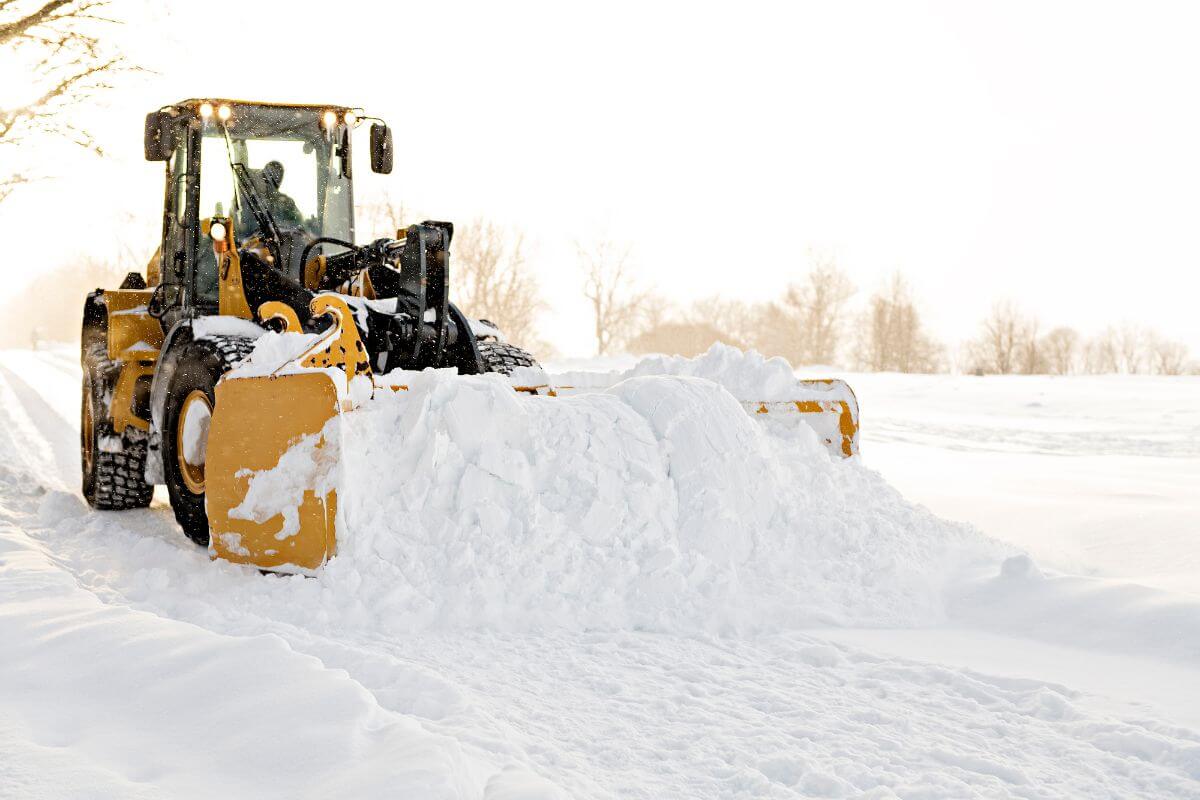A bulldozer clears a Montana road of snow.