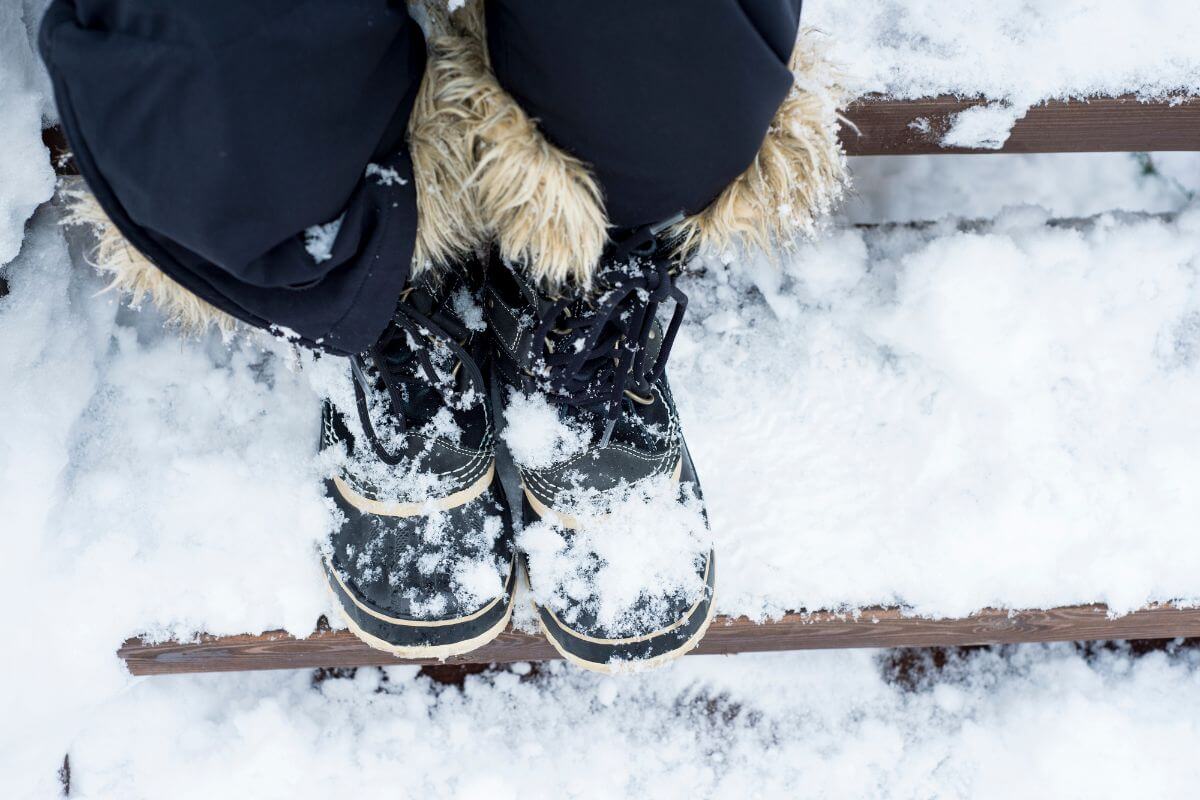 Winter boots designed with fur on snowy outdoor steps